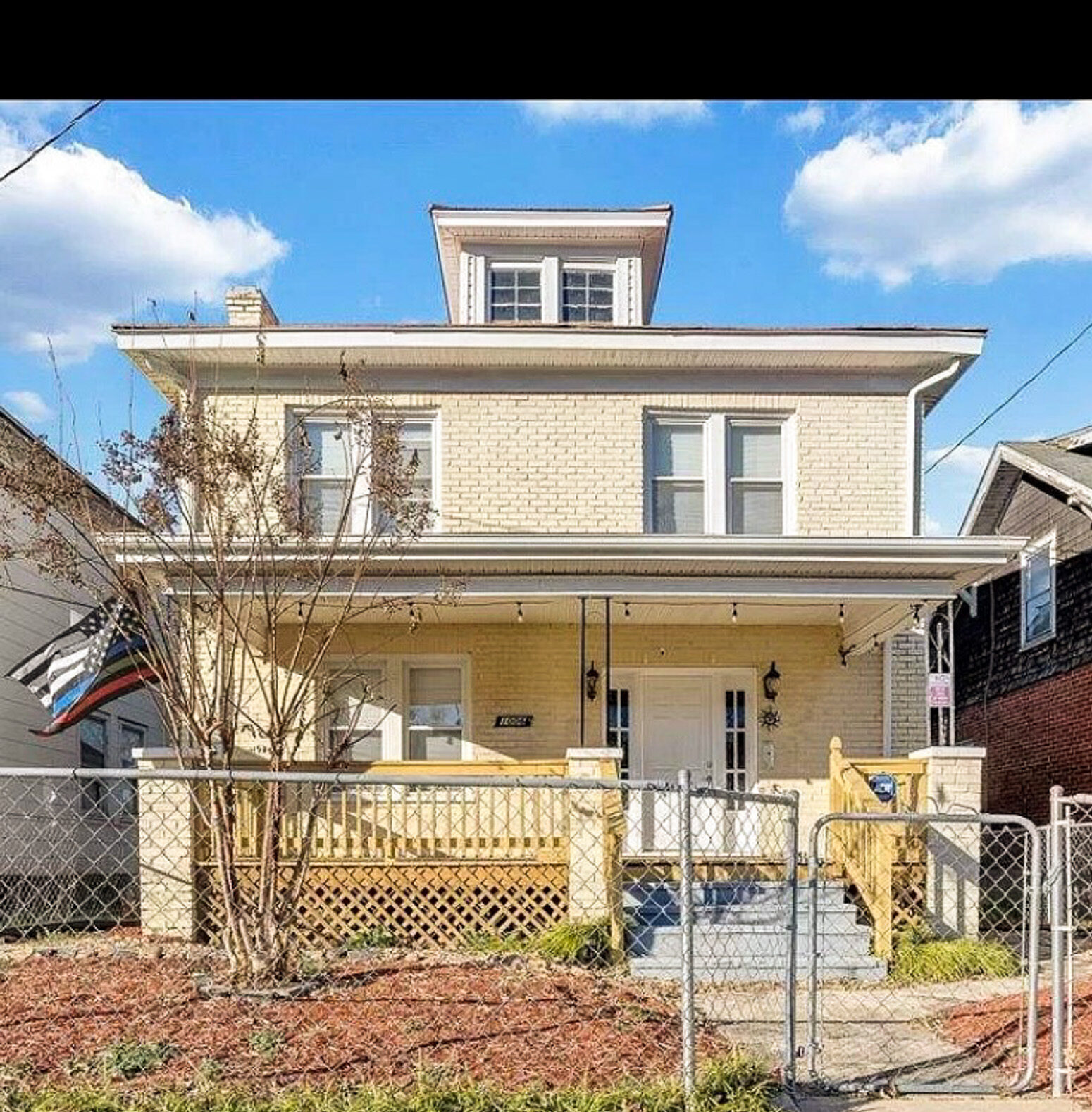 A two‑story house with a covered front porch, fenced front yard, and new wooden steps leading to the entrance belonging to Sponsored Residential Provider Jessica Peregrino in Roanoke, Virginia.