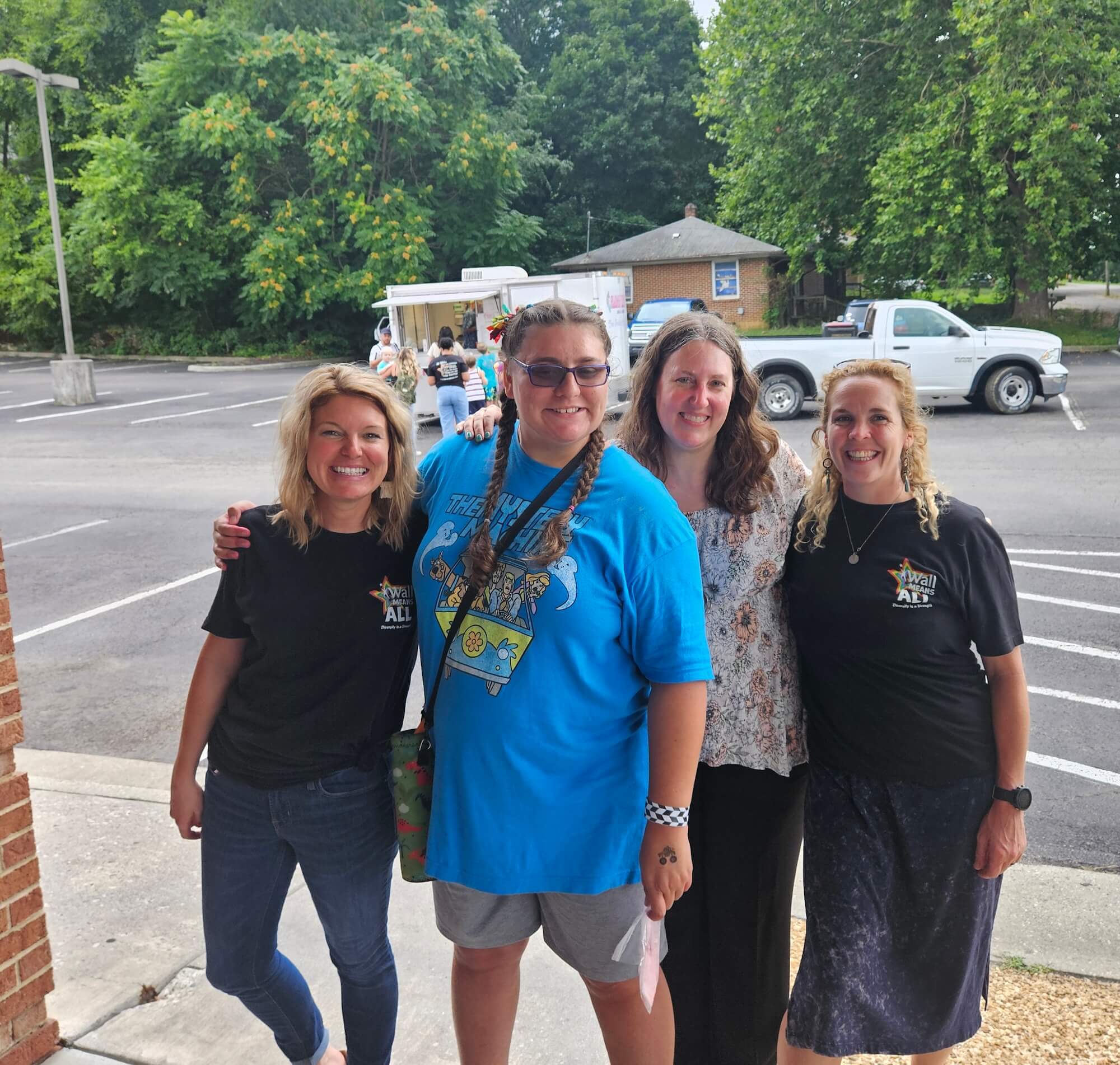 A group of four women gathered together outside the grand opening of the ABA Center in Christiansburg