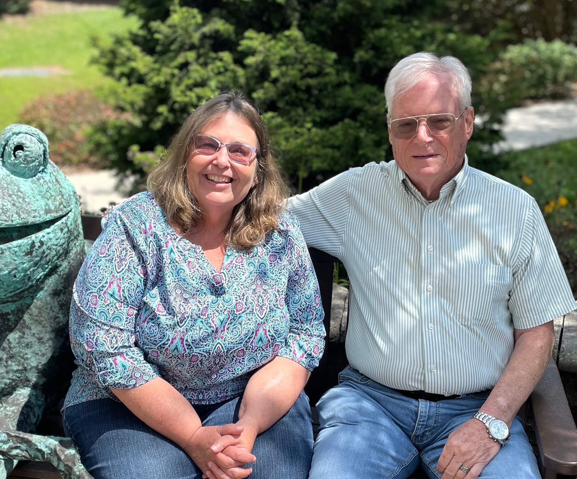 The founders of Wall sitting on a bench, smiling at the camera